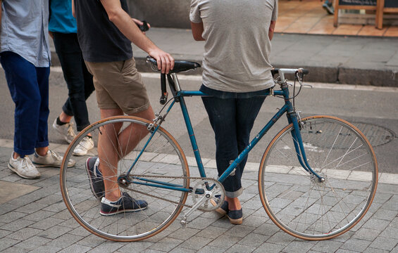 people walking , and sit on a bike in the city