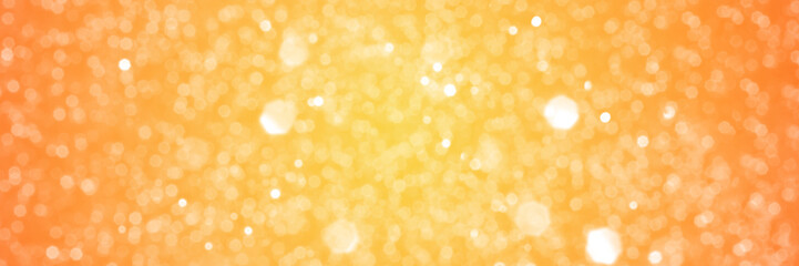 Summer orange sparkling glitter bokeh background, banner texture. Abstract defocused lights header. Wide screen wallpaper. Panoramic web banner with copy space for design