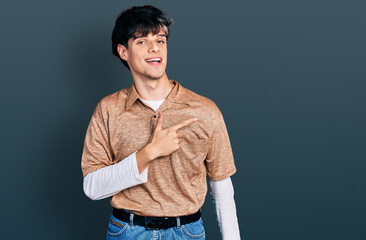 Handsome hipster young man wearing 90s retro style smiling cheerful pointing with hand and finger...