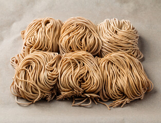 Raw handmade noodles on the parchment paper