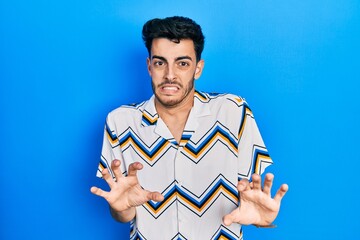 Young hispanic man wearing casual clothes disgusted expression, displeased and fearful doing...