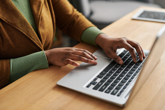 Hands Of Young Self Employed Black Woman In Smart Casualwear Typing On Laptop Keyboard By Workplace While Consulting Online Patients