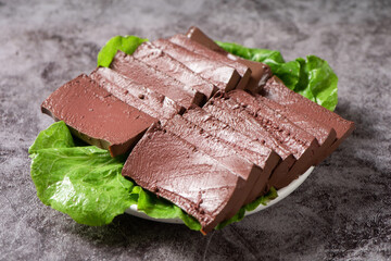 slice of coagulated duck blood on table