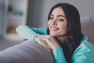 Photo of young adorable lovely woman sit divan living room weekend imagination rest think imagination indoors