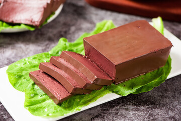 slice of coagulated duck blood on table