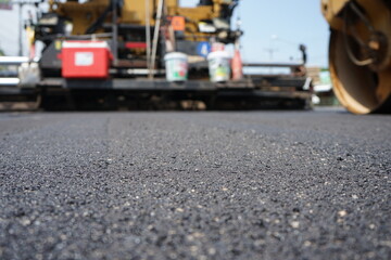 The image is blurred in the construction of asphalt road.