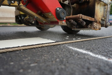 Technicians are marking a traffic line on a paved road.(Blurred picture)