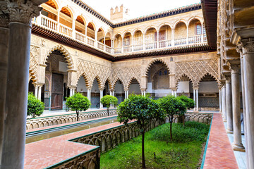 Fototapeta premium Beautiful formal public garden inside Alcazar Seville palace in summertime in Andalusia
