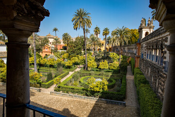 Fototapeta na wymiar Beautiful formal public garden inside Alcazar Seville palace in summertime in Andalusia