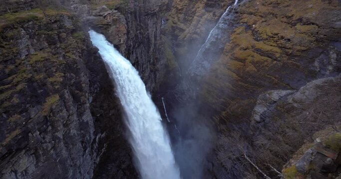 Spectacular waterfall in to canyon,  Norway