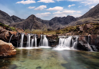 Fototapeta na wymiar Mountain landscape with waterfall In Isle of Skye, Scotland - Fairy pools