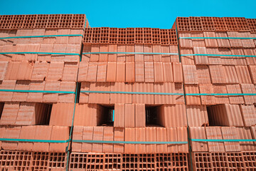 Pallets with freshly made racks of bricks at a construction site or near an industrial plant. Storage of building materials at the warehouse
