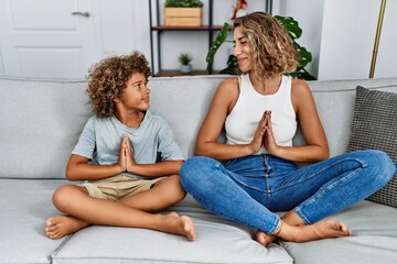 Mother and son meditating doig yoga exercise at home