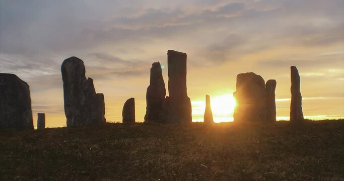 4k timelapse cloud and light movement over Callanish Stones at sunrise. Stones in silhouette. No people. Famous prehistoric standing stones, Isle of Lewis, Outer Hebrides, Scotland