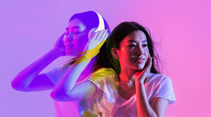 Attractive asian woman dreaming about new wireless headphones