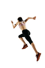 Rear view of young caucasian woman running isolated on white studio background. One female runner or jogger. Sport, track-and-field athletics, competition concept