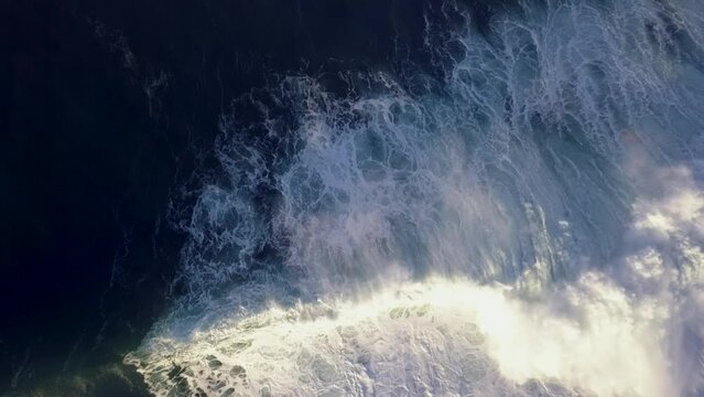 Aerial view overhead waves breaking in the ocean