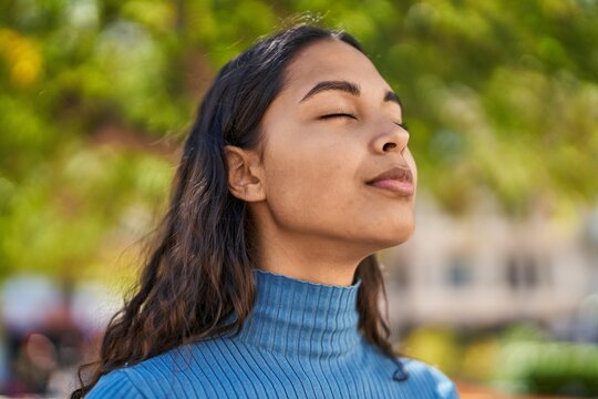 Young african american woman smiling confident breathing at park