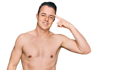 Fototapeta premium Handsome young man wearing swimwear shirtless smiling pointing to head with one finger, great idea or thought, good memory