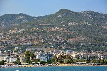 Fototapeta na wymiar Alanya town with waterfront and mountains on background
