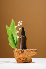 Natural medicine or aroma oil or beauty essence concept vial with dropper on stone podium stand...