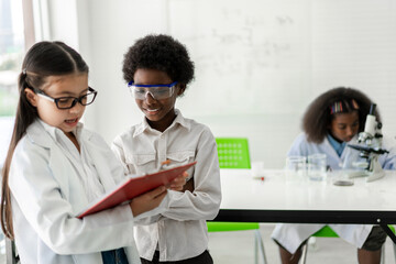 Group of teenage student learn science with teacher and study doing a chemical science experiment...