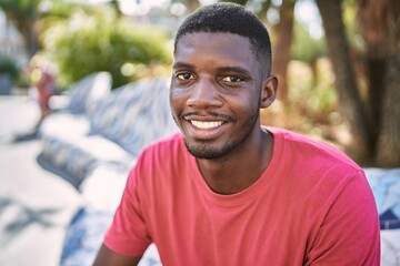Fototapeta premium Young african man smiling confident at park