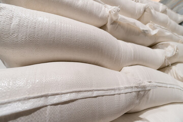 Close-up of white flour bags in a warehouse or production
