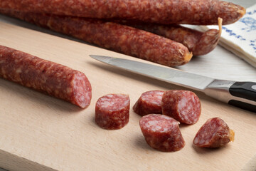 Traditional Dutch sausage called Rotterdammetje and slices on a cutting board close up 