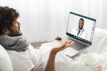 Fototapeta na wymiar Patient having video conference with doctor from home