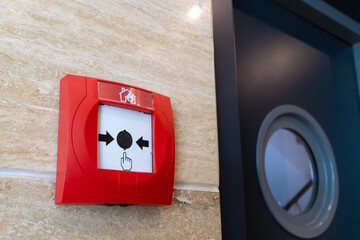 Close-up of the fire alarm switch on the wall in the corridor