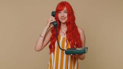 Hey you, call me back. Cheerful ginger woman secretary in tank top talking on wired vintage...