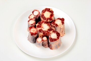 Raw uncooked ox or cow tail on white isolated background