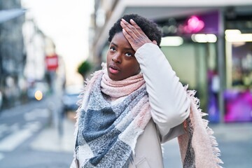 African american woman standing with worried expression at street