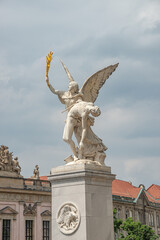 Roman statue of an angel holding a fighter at war at Schloss Bridge near Berlin Cathedral and Unter...