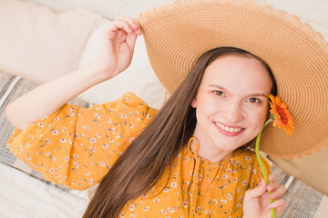 Portrait of a beautiful girl with a flower in her hands