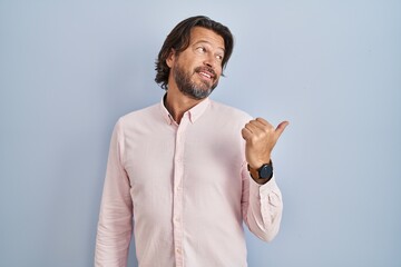 Handsome middle age man wearing elegant shirt background smiling with happy face looking and...