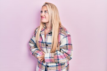 Young blonde girl wearing casual clothes with hand on stomach because nausea, painful disease feeling unwell. ache concept.