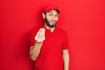 Hispanic man with beard wearing delivery uniform and cap doing italian gesture with hand and fingers confident expression