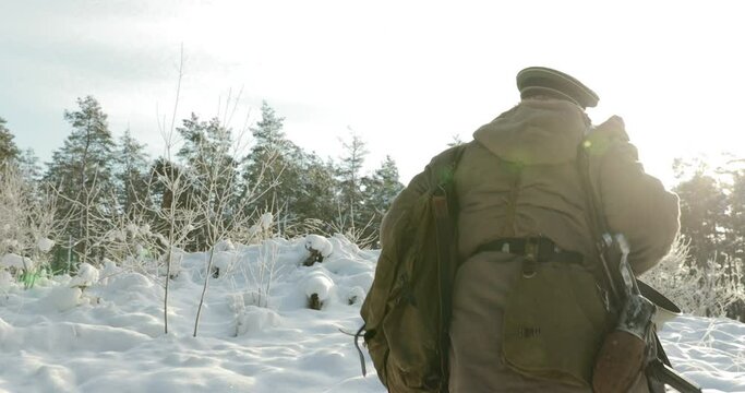 4K Re-enactor Dressed As German Wehrmacht Infantry Soldier In World War II Walking With Weapon In Winter Snowy Forest.
