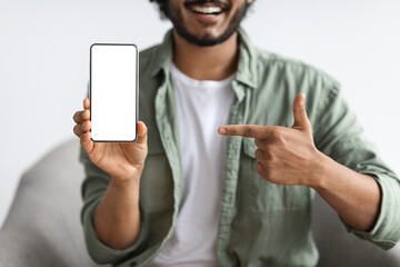 Cropped of man pointing at smartphone with empty screen