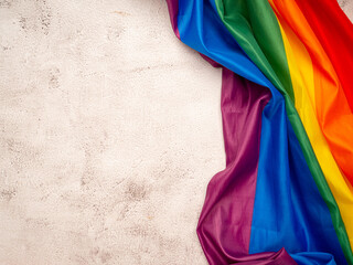 Pride month. Top view of the rainbow flag or LGBT is on a cement floor background
