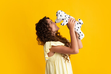 Childhood, toys and kids. Cute teen girl cuddling fluffy toy. Happy teenager, positive and smiling...