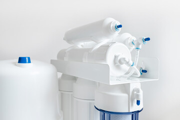 White and blue water filtration osmosis system with a carbon filter for clear water shot on a white...