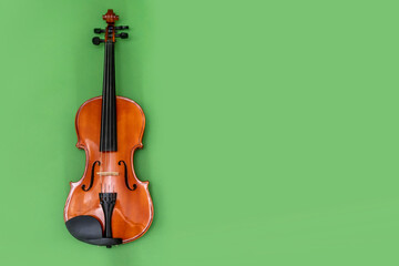 Classical music concert poster with orange color violin on green background with copy space for your text. online music courses. Invitation card with place for text