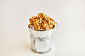 Walnuts in a metal mini-bucket.