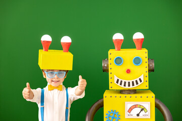Fototapeta na wymiar Happy child with toy robot in class