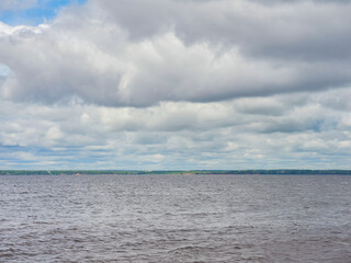 Fototapeta premium The front view in the morning sky is bright blue with transparent white clouds. And the ocean depths of indigo in daylight. A feeling of calmness, coolness, relaxation. An idea for a cool background a