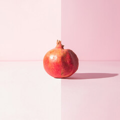 Two parts of one pomegranate, half fresh, half wrinkled. Time and aging concept.