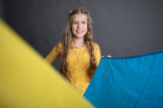 Littl girl holding Ukrainan flag